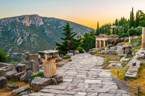 Ancient Greek ruins, sunset, mountain in the background