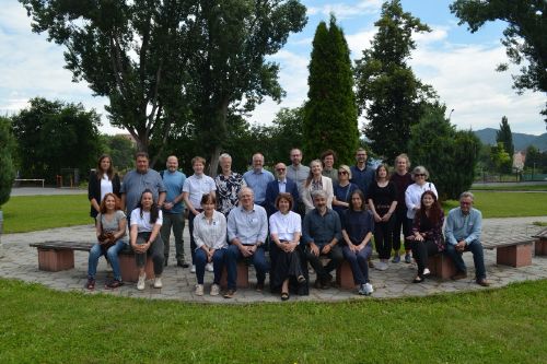 Group photo of the consortium for the SeCreTour project. Two rows of people surrounded by lush greenery