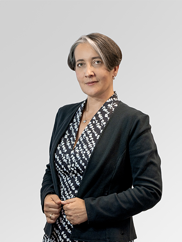 A portrait of Darja Podgornik, Chief financial officer. She is a middle-aged woman with brown hair, wearing a white black shirt and a black jacket, smiling.