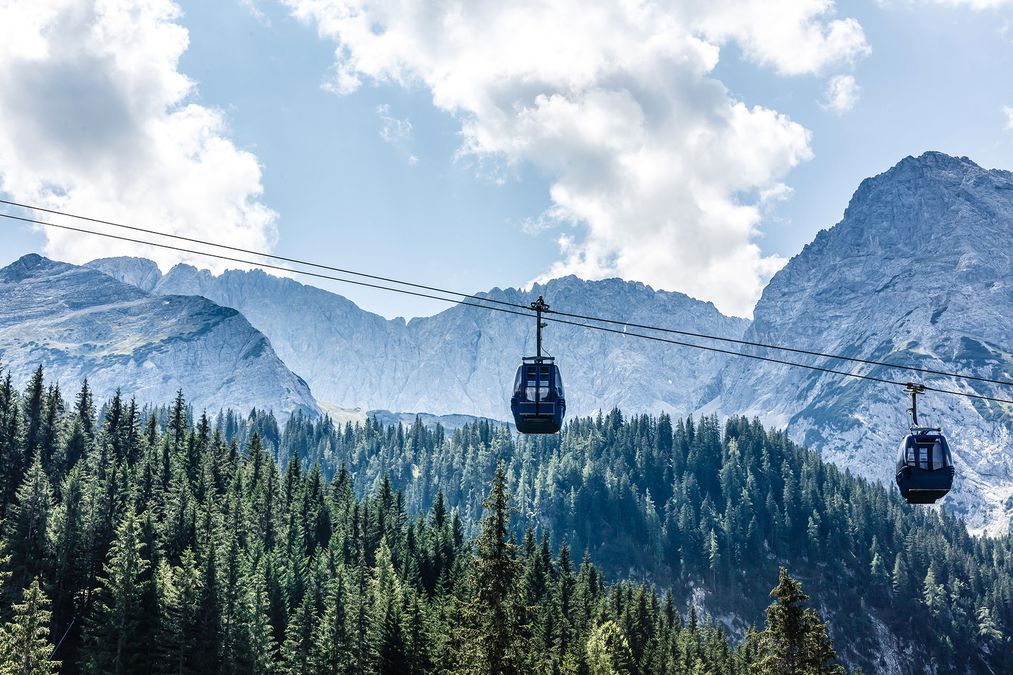 Cable car going up the mountains, without snow